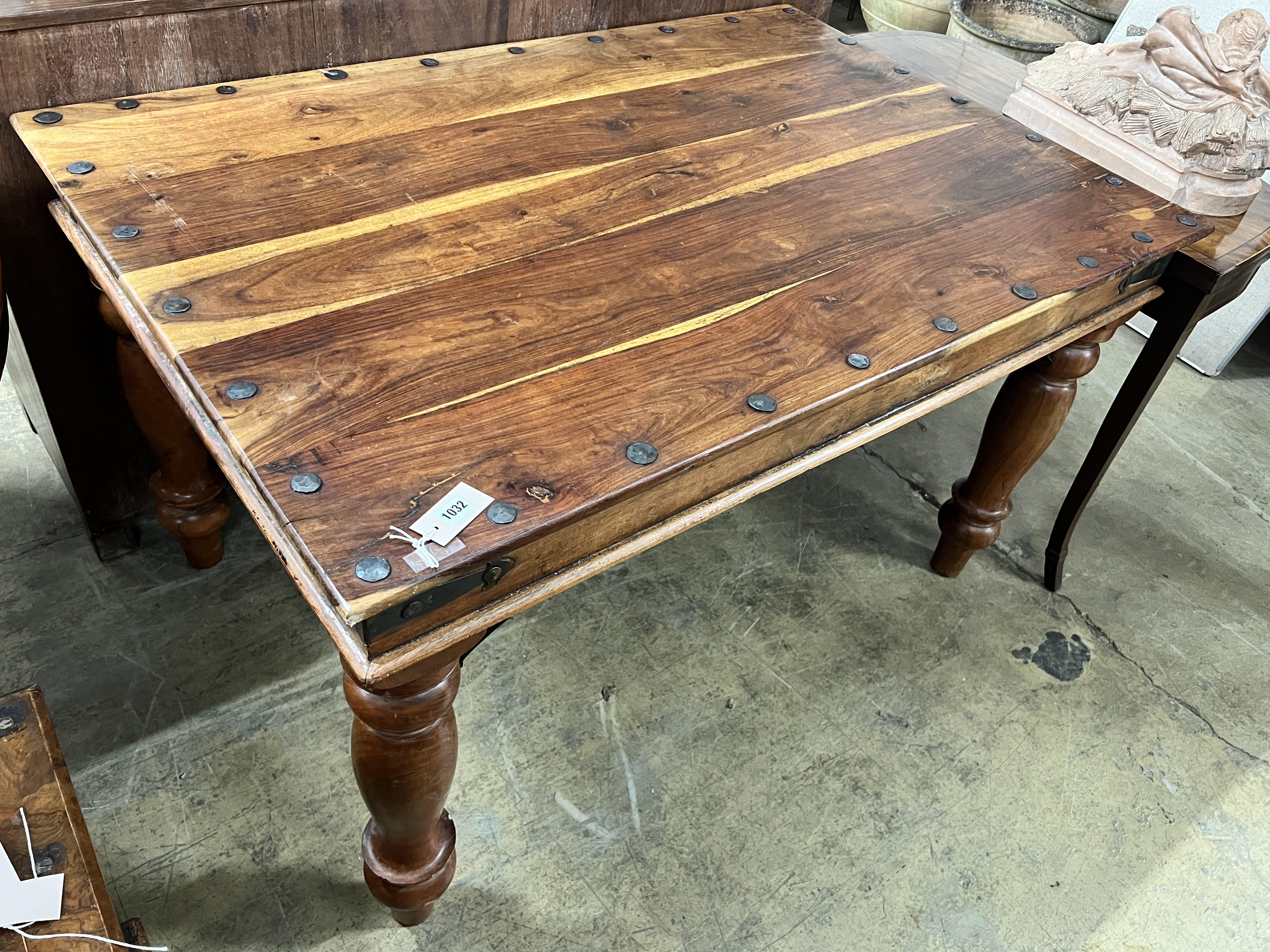 A rectangular Indonesian studded hardwood dining table, width 135cm, depth 90cm, height 79cm